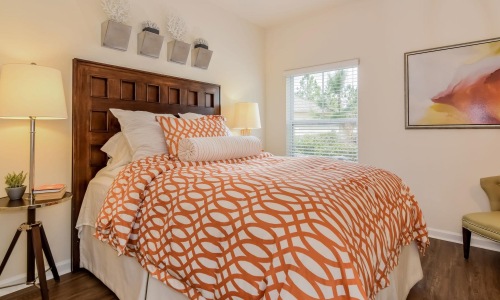a bedroom with a bed and lamps