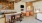 a kitchen with a bar and chairs