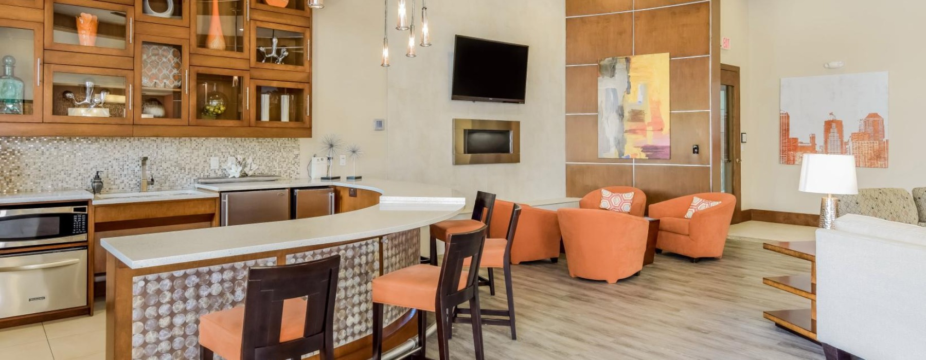 a kitchen with a bar and chairs