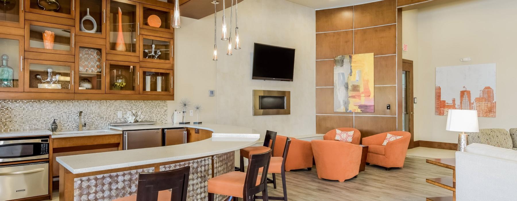 a kitchen with a bar and chairs