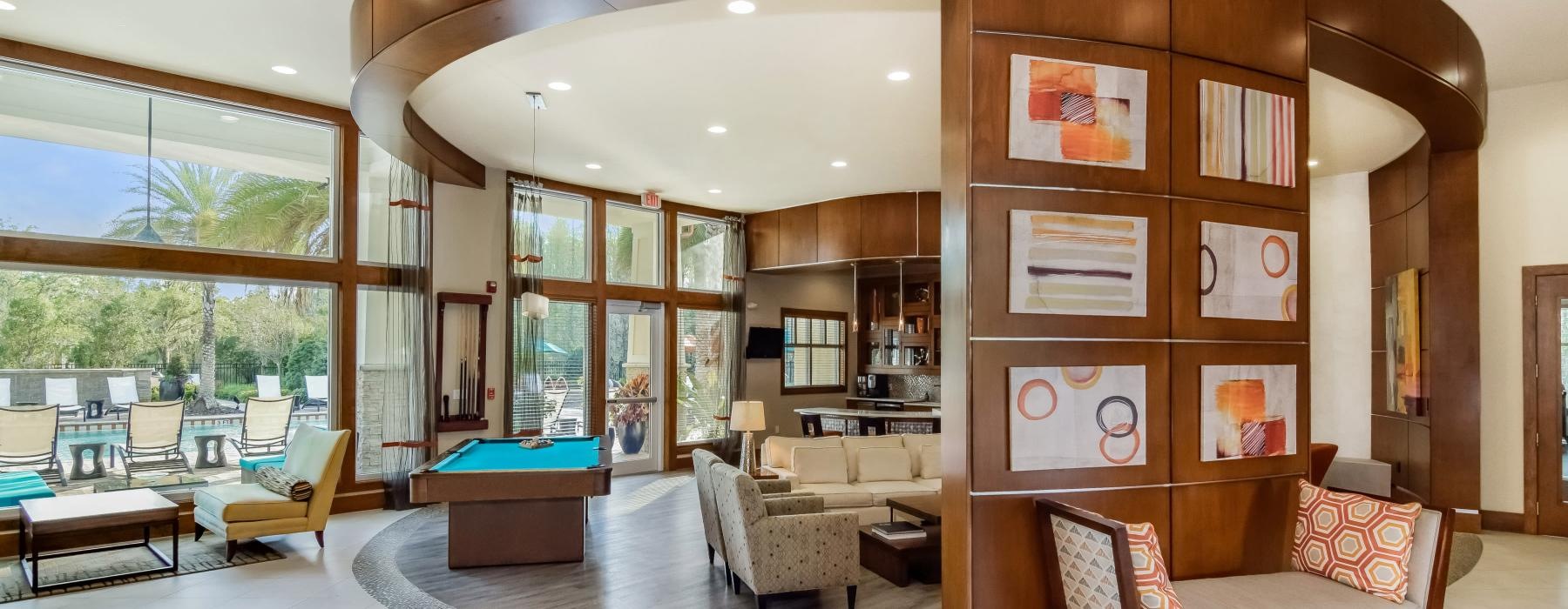 a game room with a pool table and windows