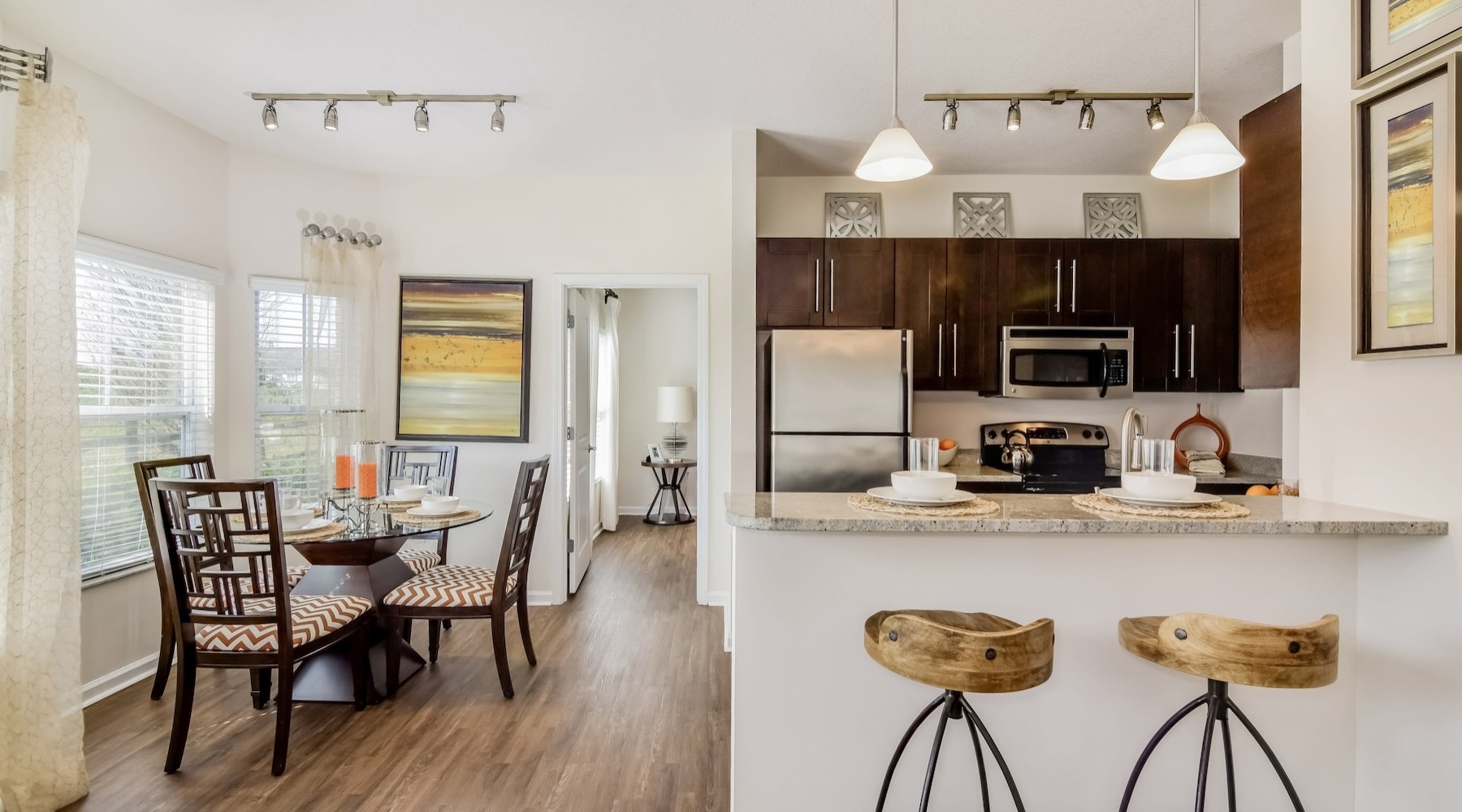 kitchen with barstools and dining room table with chairs